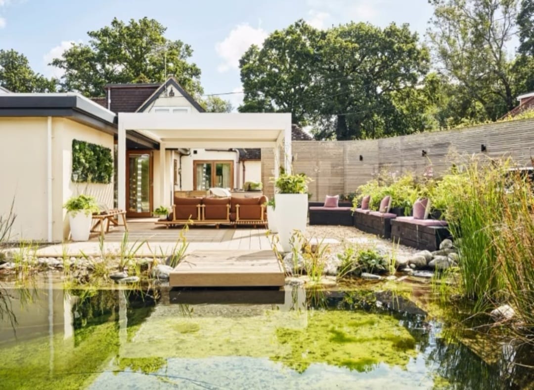 A beautiful outdoor retreat area with a pond and deck